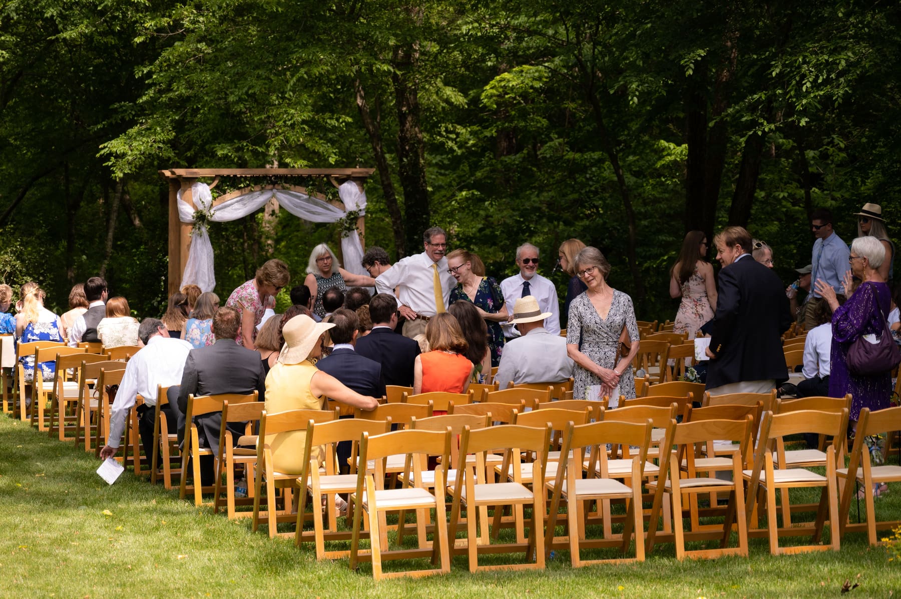 Wide ceremony view under the trees