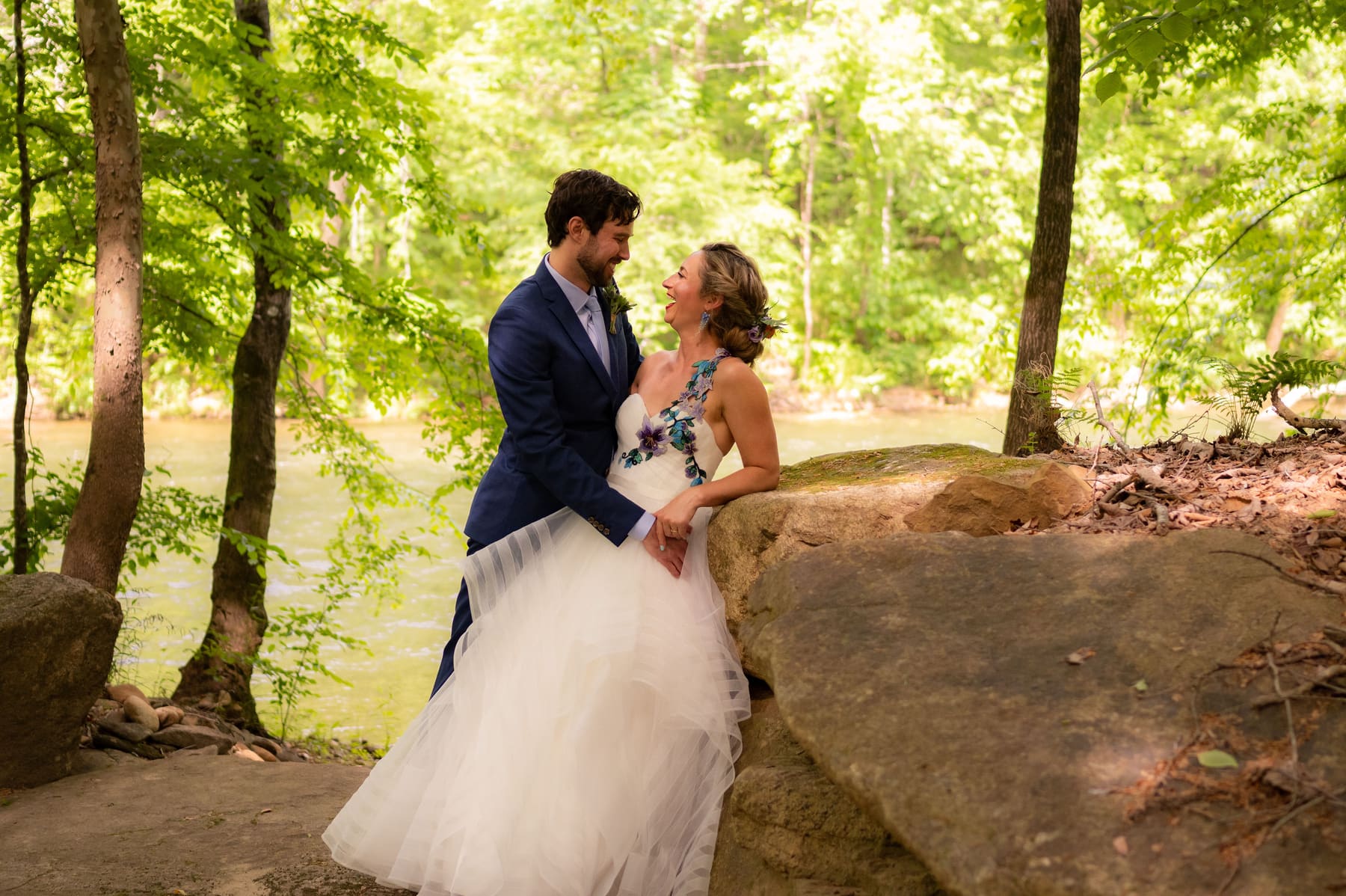 Lillian and Steven standing together in a wooded portrait location