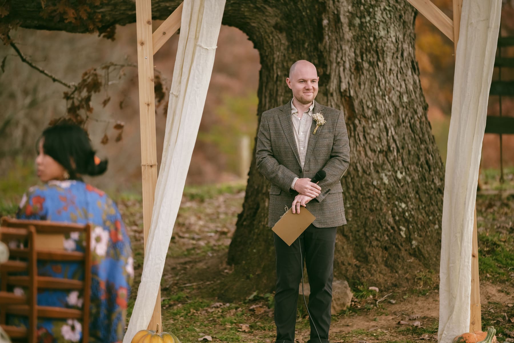 Officiant waiting beneath the ceremony arch