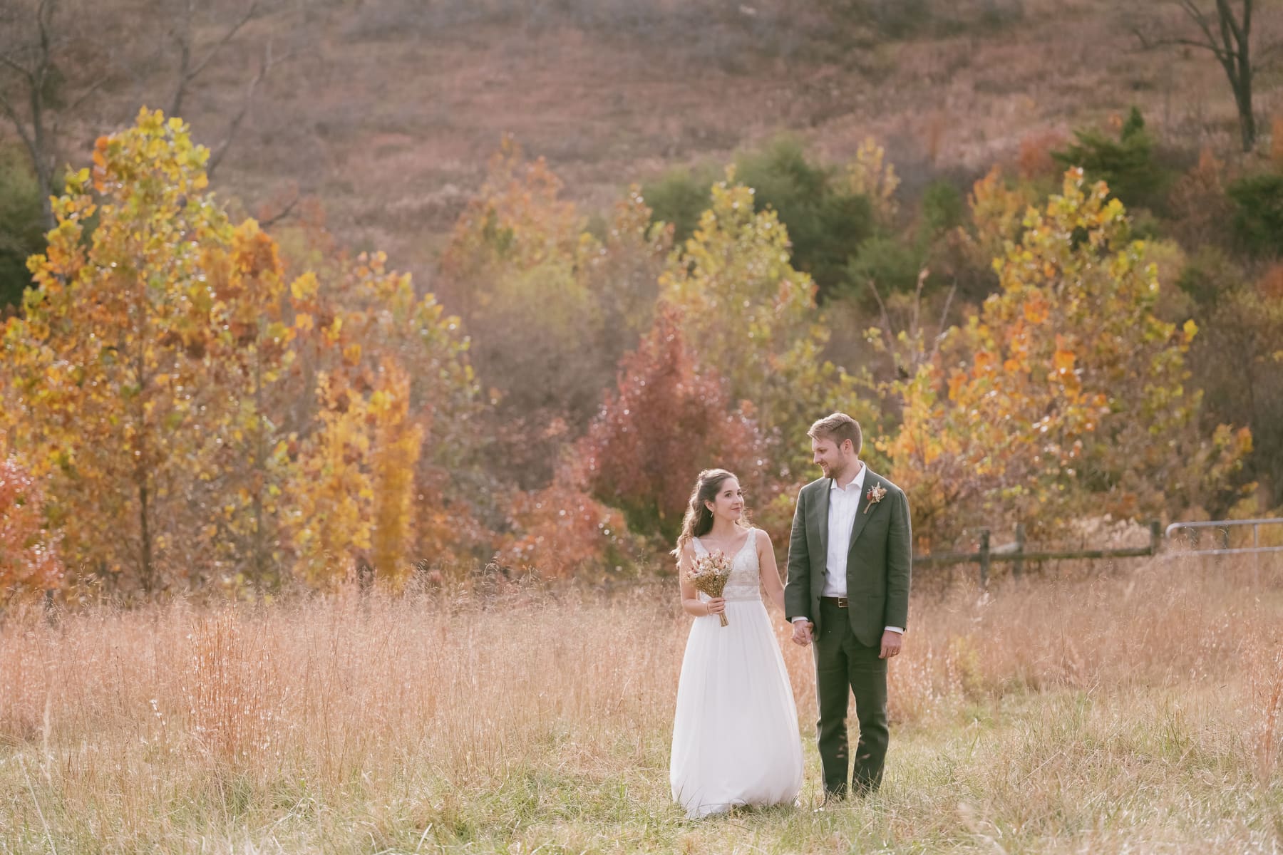Robin and Jacob standing together in a fall hillside portrait